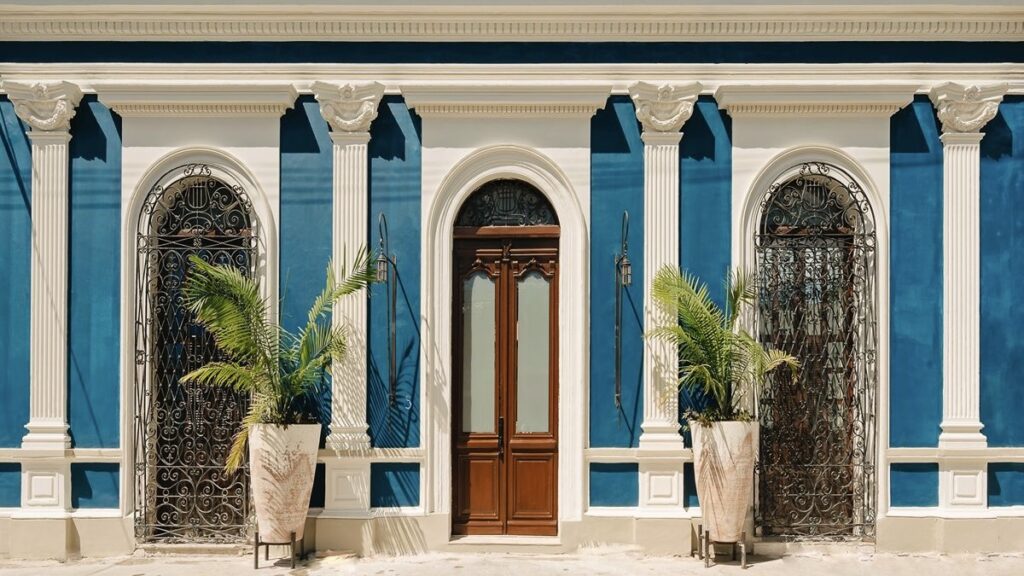 Hotel Cigno blue facade with palms