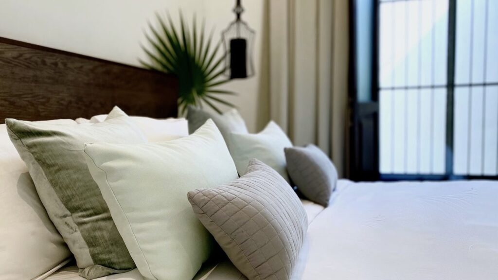 The Diplomat Boutique Hotel bed with pillows